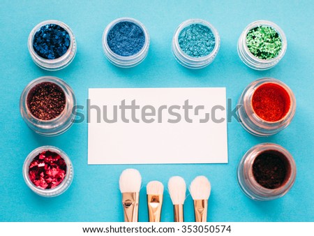 Layout for banner advertising for the makeup artist. Shadows, brushes, and business card on a bright turquoise background
