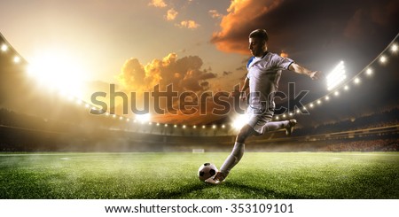 Soccer player in action on sunset stadium background