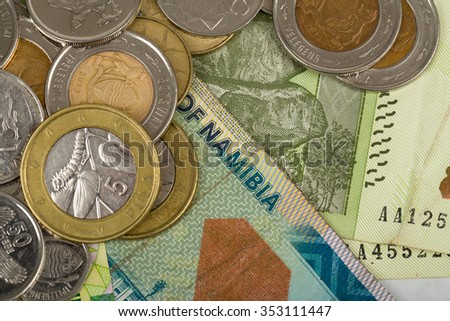 South african countries banknotes and coins for background. Botswana pula, Namibian dollar, South Africa rand and Zimbabwe dollars.