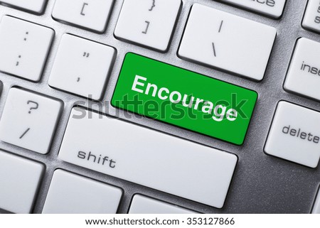 Closeup picture of Encourage button of keyboard of a modern computer.