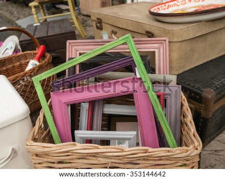 Differed coloured painted wood frames in a basket for sale at a vendor in Hay-on-Wye, Wales, United Kingdom, Europe.