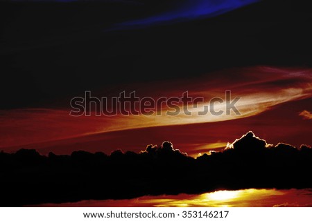 The abstract toning of a bright colorful sunset behind a distinctive cloud band / Abstract sunset
