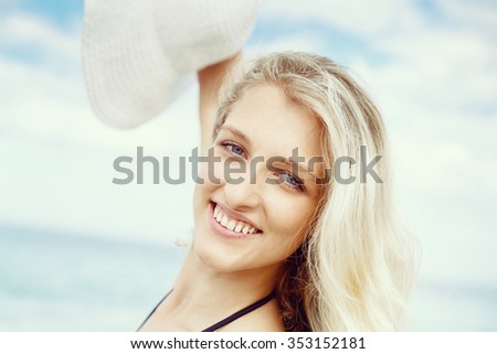 Portrait of young pretty woman at the beach