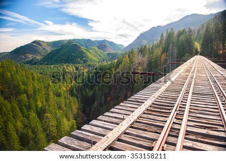 Marvelous mountains with green forest are visible from an unfinished railway bridge in Washington