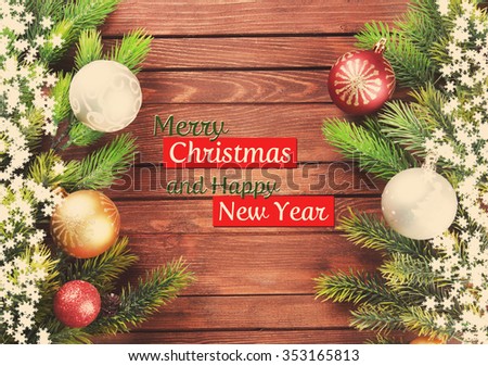Christmas fir tree branches with toys on wooden table