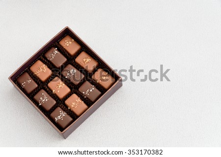 Special occasion box of salted caramel chocolates on a silver background
