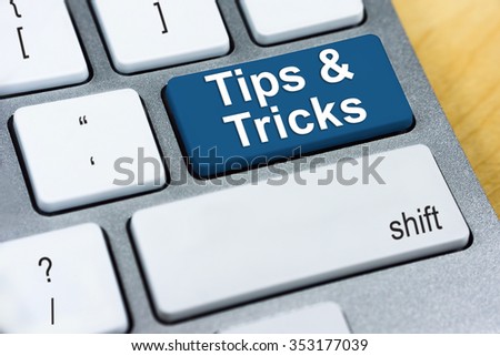 Education concept: Written word Tips & Tricks on blue keyboard button.