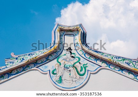 Chinese style painting on white wall of shrine in Thailand. on cloud and blue sky background 