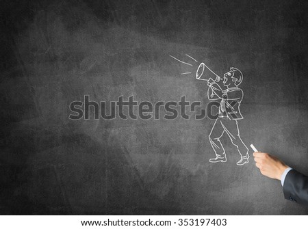 Male hand drawing with chalk sketch of businessman on blackboard