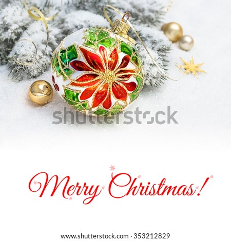 Christmas greeting card. Christmas bauble with poinsettia design, decorated branches of Christmas tree on snow. Space for your text on plain white background below the picture.