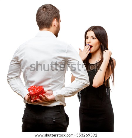 Young beautiful caucasian couple with present isolated on white