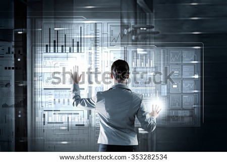 Businesswoman pushing with finger icon on virtual screen 