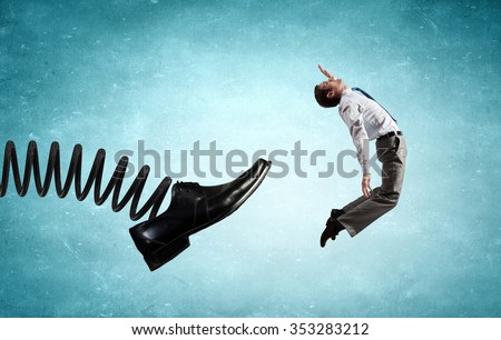 Businessman kicked by his boss foot on spring Royalty-Free Stock Photo #353283212