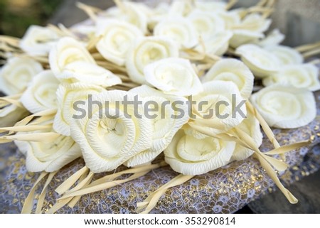 White artifical flowers (used during a funeral) - kind of wood flower to be placed on the site of cremation in Thailand.