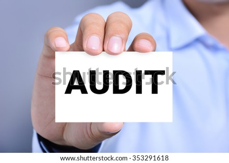 AUDIT word on the card shown by a man