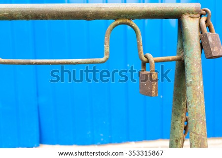 Vintage lock on the background of blue wall at the construction site