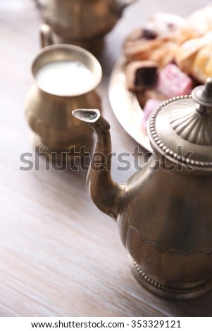 Antique tea-set with Turkish delight and baking on table close-up