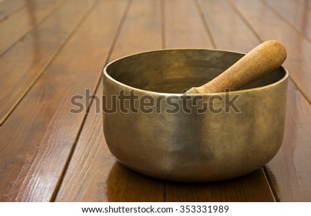 Metal singing bowl on a wooden surface 