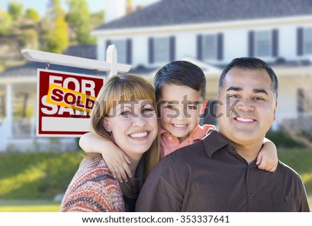 Happy Mixed Race Young Family in Front of Sold Home For Sale Real Estate Sign and House.