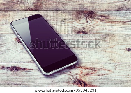 Realistic mobile phone iphon style mockup with black screen and shadows on wooden background. Highly detailed illustration.