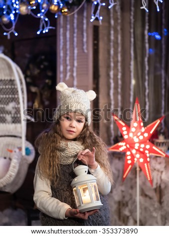 pretty little girl with flashlight at christmas time