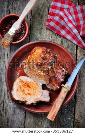 Grilled pork chop on a wooden background