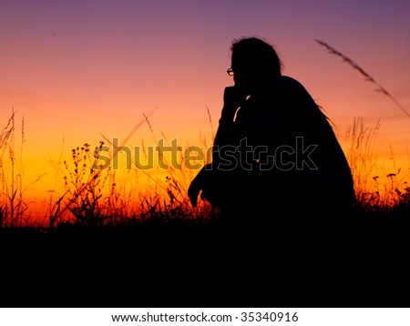 Thinking men silhouette in sunset