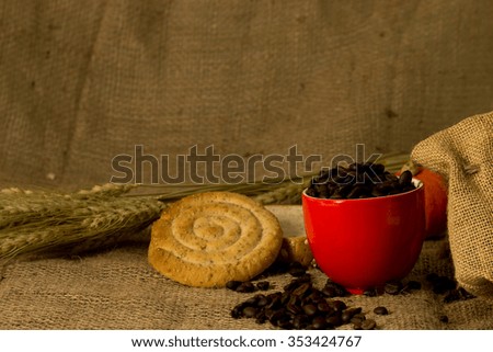 Red cup and Coffee beans on hemp sack background, still life and vintage