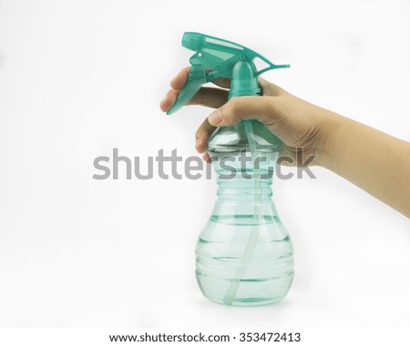 Spray bottle in woman hand on white background