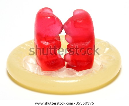 Loving red jelly bears couple on a condom - conceptual image - on white background Royalty-Free Stock Photo #35350396