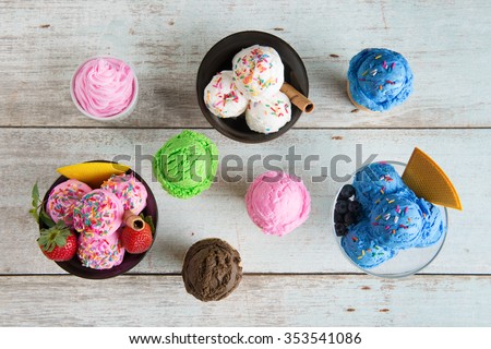 Top view strawberry, blueberry and vanilla ice cream in bowl on white rustic wooden background.