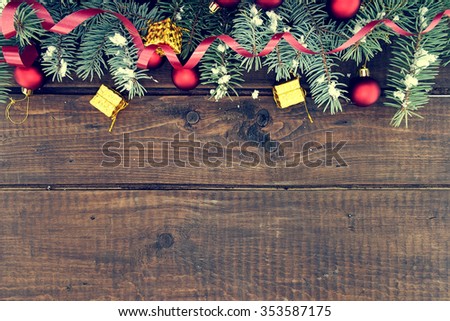 Composition with decorated Christmas tree on dark rustic wooden background with copy space for text. Christmas mock-up or greeting card. Top view.