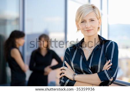 Outdoor portrait of attractive young businesswoman, smiling.