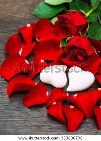 Red roses and two hearts. Valentines Day decoration. Dark toned picture
