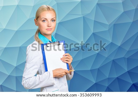 Portrait of happy female doctor holding blank paper on clipboard 
