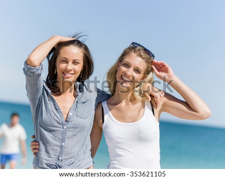 A picture of two women having good time on beach