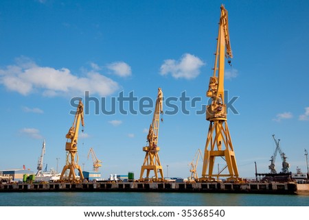 Cranes of the dockyards of C?diz in a sunny day