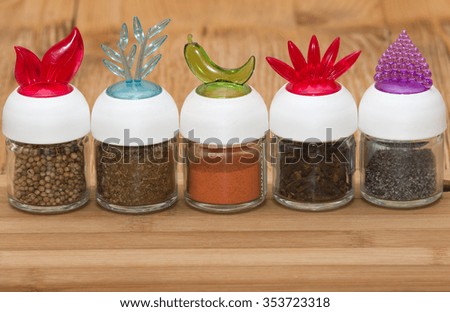 Spices in bottles  on the wooden table