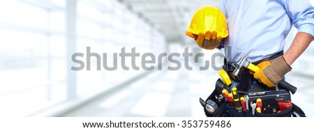 Builder handyman with construction tools. House renovation background. Royalty-Free Stock Photo #353759486