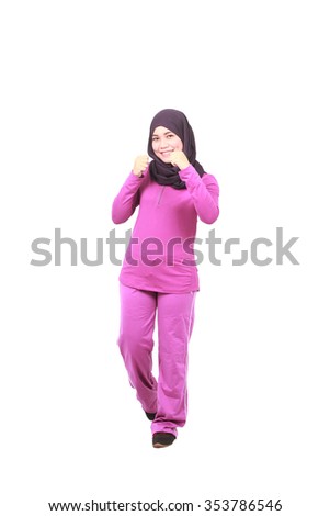 Young female muslim doing exercise with white background