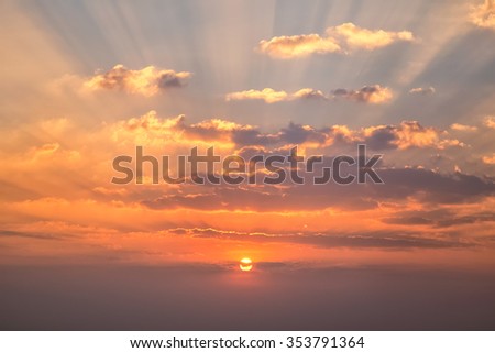 Sunset with clouds, light rays and other atmospheric effect Royalty-Free Stock Photo #353791364