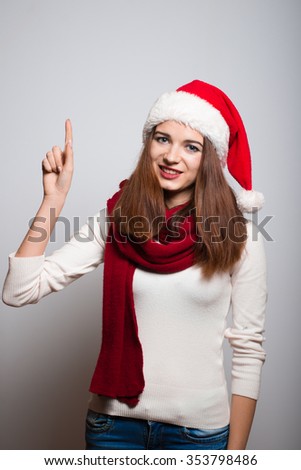 Santa girl has a good idea. Christmas hat isolated portrait of a woman on a gray background.