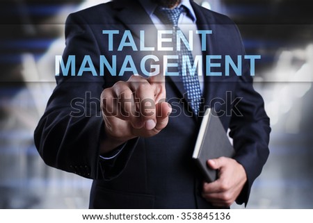 Businessman pressing button on touch screen interface and select "Talent management". Business concept. Internet concept.
