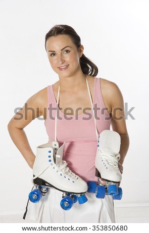 Portrait of a female roller skater carrying quad boots over her shoulder