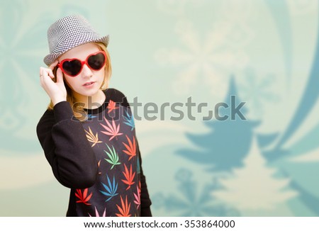 Picture of beautiful young lady in fancy sunglasses and hat. Pretty girl on digital winter theme blurred background.