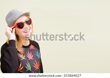 Picture of beautiful young woman in fancy sunglasses and sweater. Pretty girl on copyspace blurred background.