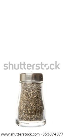 Salt and peppercorn powder in glass condiment shaker over white background
