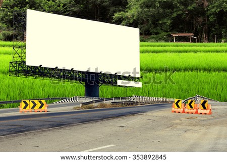 billboard and bridge with fields and forest background