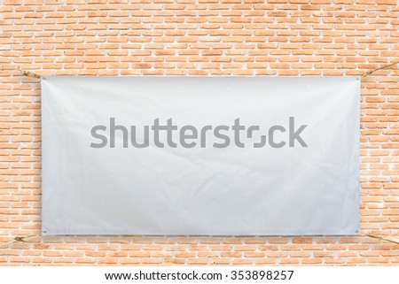 Copy space for text on disastrously white vinyl banner on brick background .Clipping path