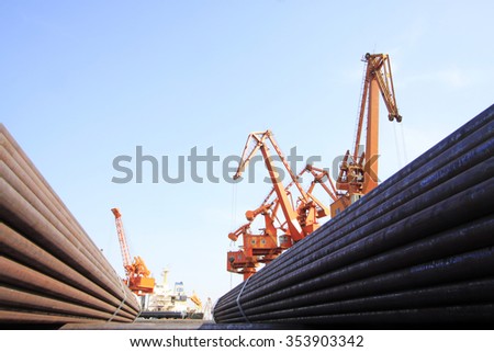 portal crane and pipes on the shipping dock, closeup of photo